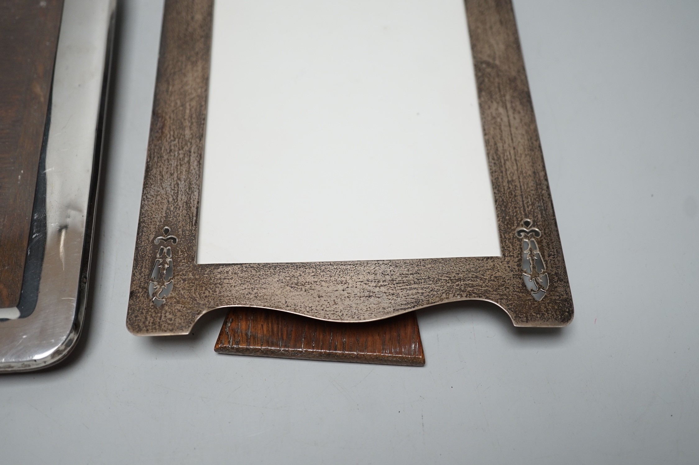 A George V pierced silver mounted photograph frame, W & F Rabone, Birmingham, 1912, 19cm and one other Edwardian silver mounted photograph frame.